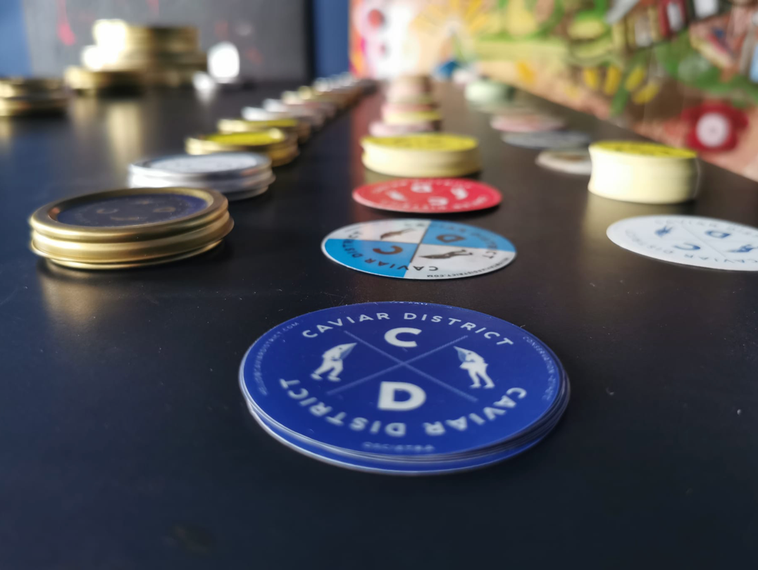 Colourful Caviar District identity pieces across a creative table